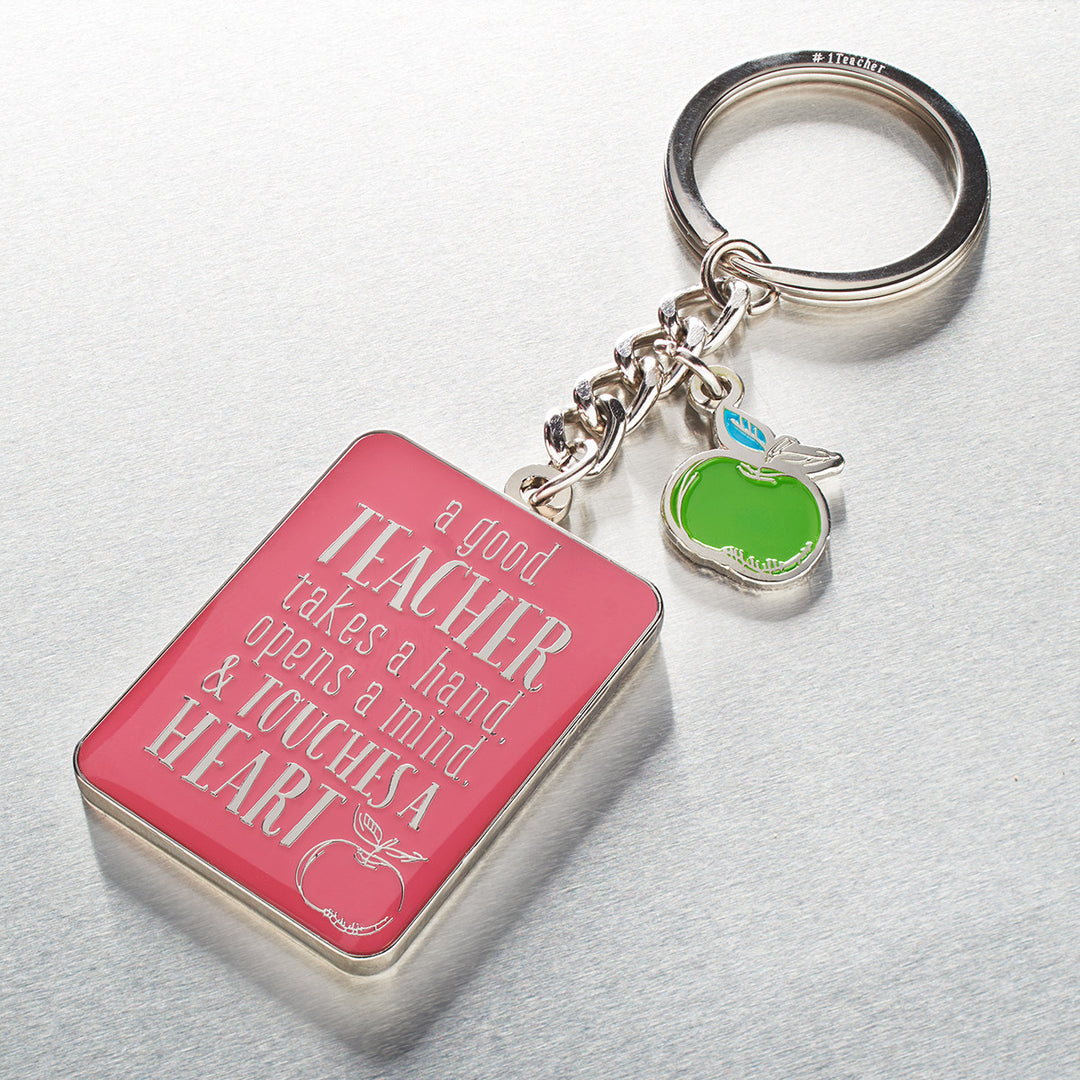 A Good Teacher Takes A Hand Pink Metal Key Ring In A Tin